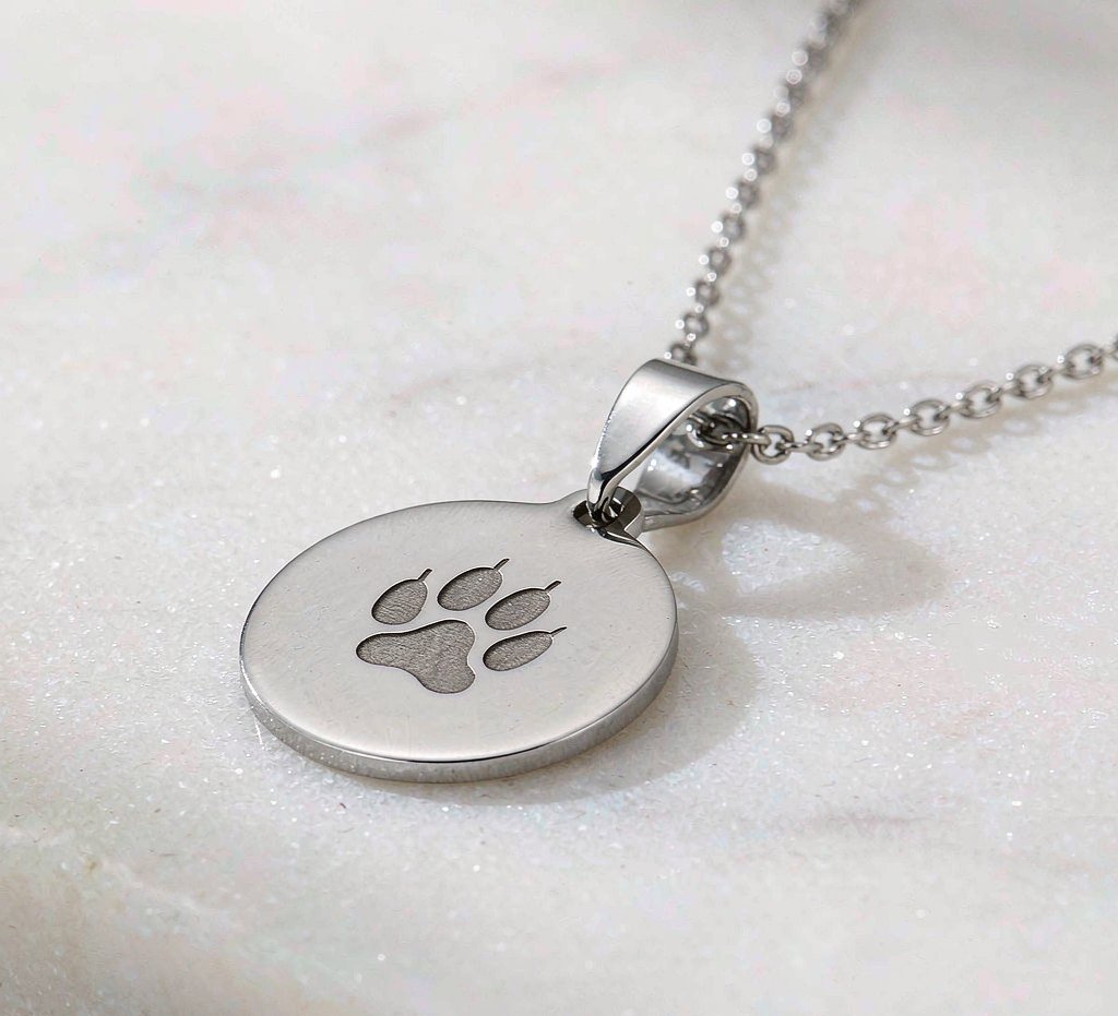 Paw print keepsake pendant in solid metal, as photographed
